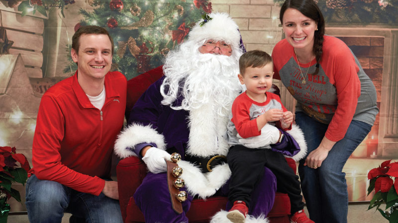 Purple Santa with family