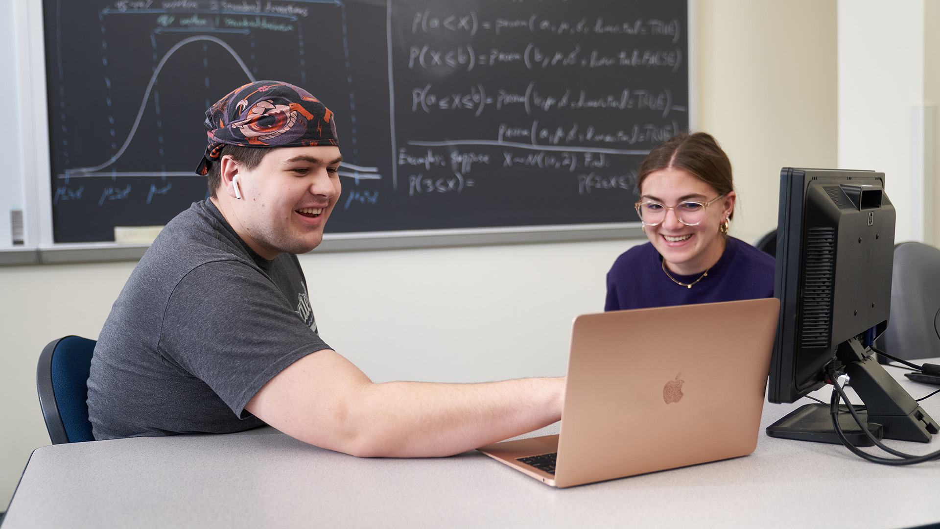 Academic Advisor with student at laptop