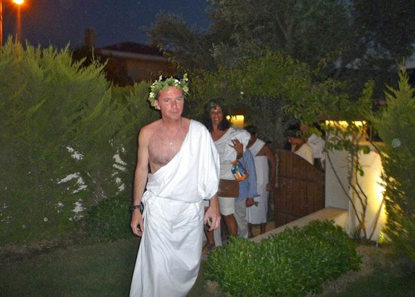 Tim O’Leary, traditional tin of Copenhagen dip in hand, leads the entourage of toga-party diehards to Izi’s house.