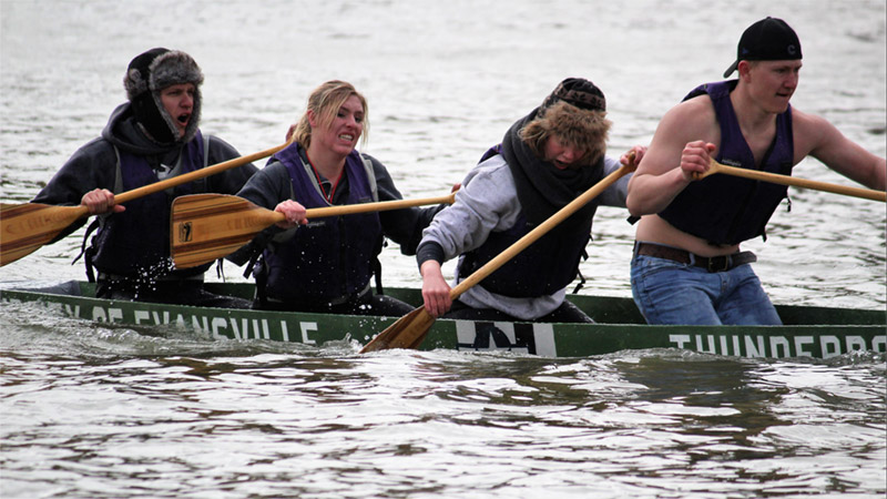 Students rowing a concrete canoe