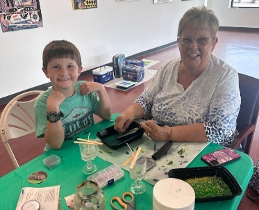 Grandparent with child at crafts table