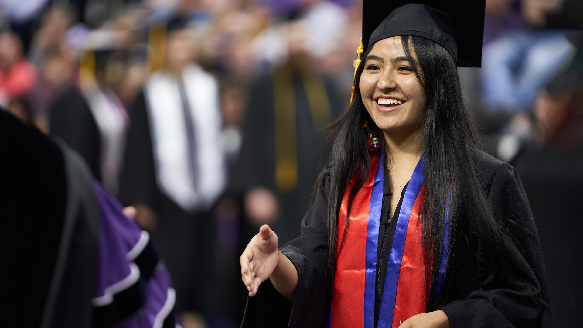 UE graduate shaking hand at commencement