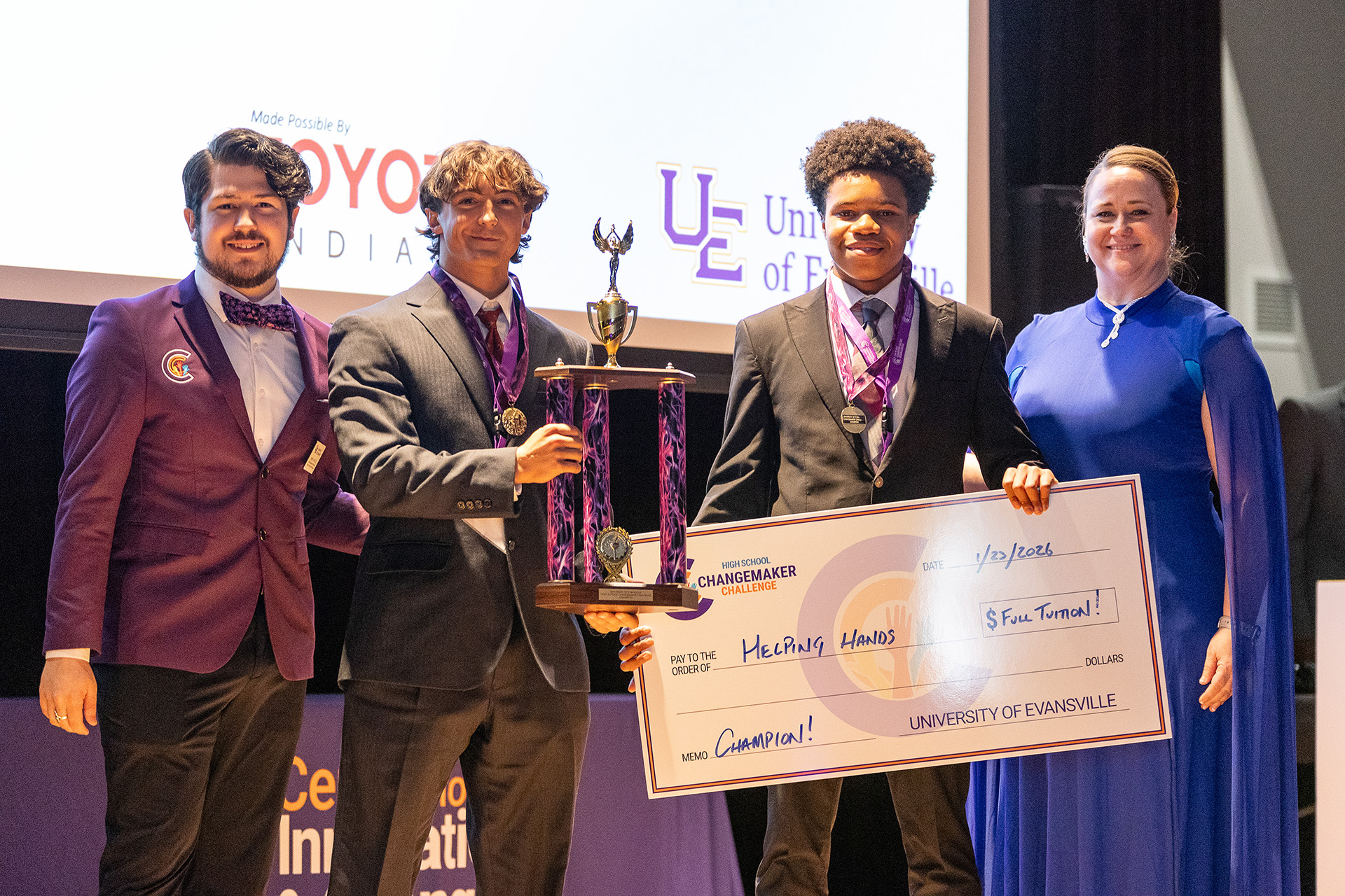Team Helping Hands holding winning check.