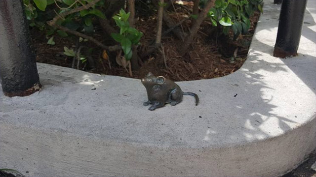 Mouse statue on curb