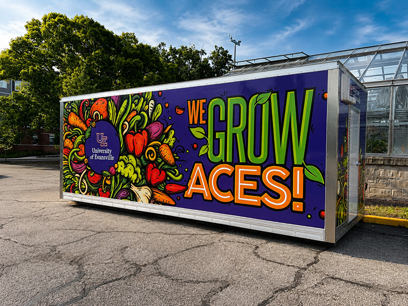 We Grow Aces container with graphics on the side