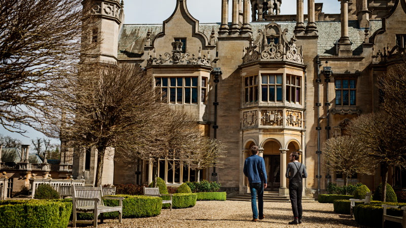 Two students walking towards Harlaxton