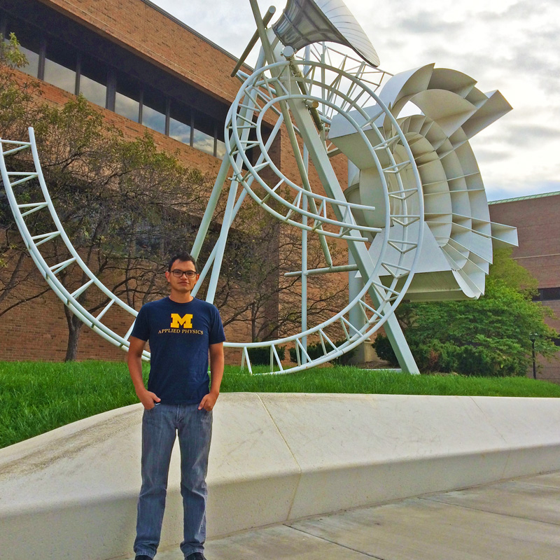 Darwin Cordovilla in front of sculpture