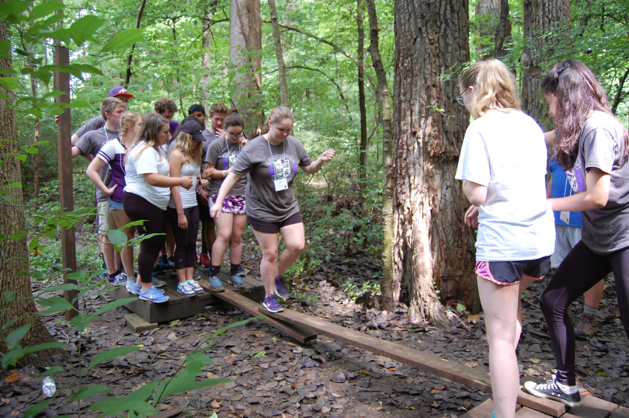 Honors freshmen work together to complete a challenge course at the freshmen retreat.