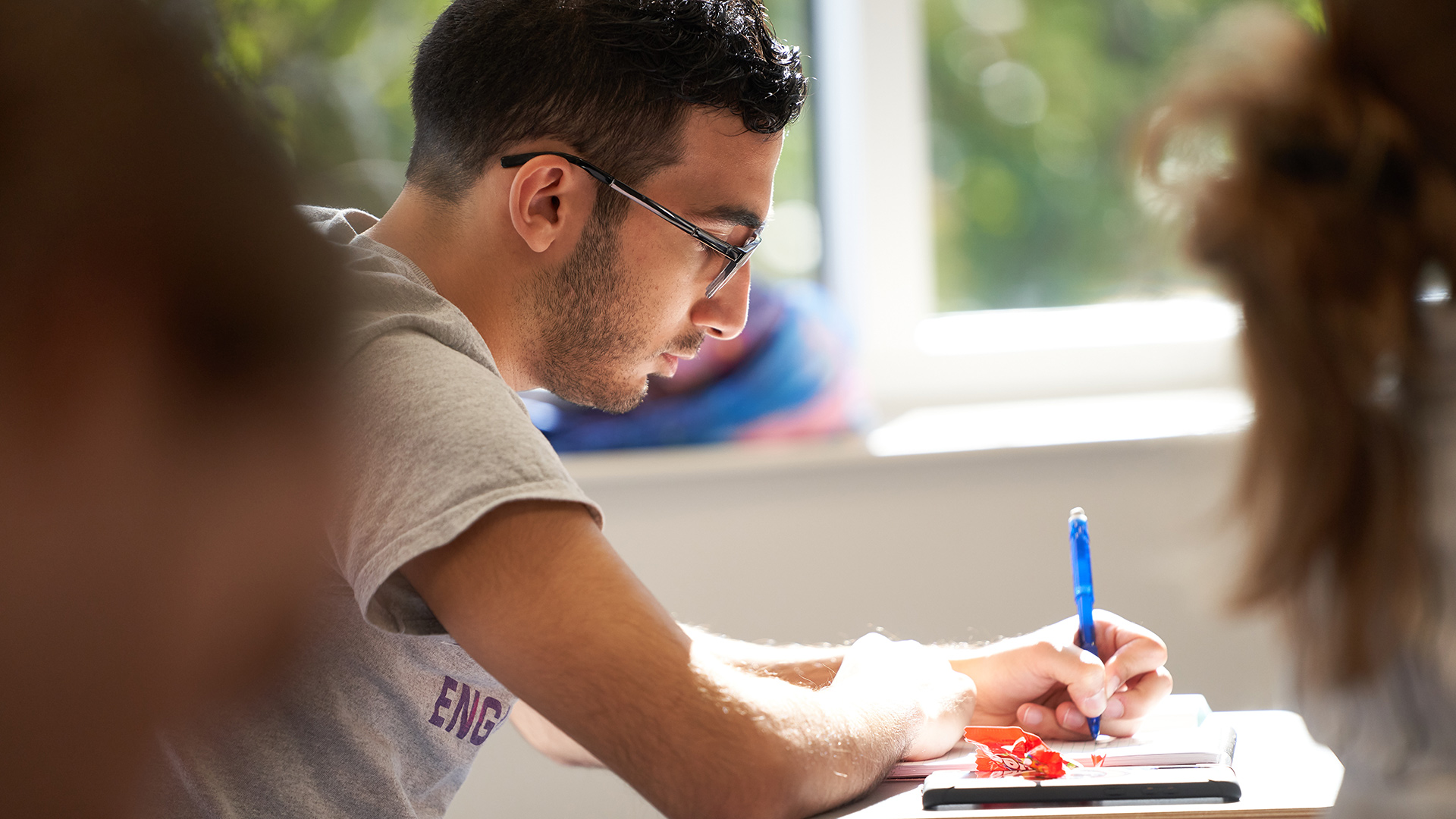 Student writing in class