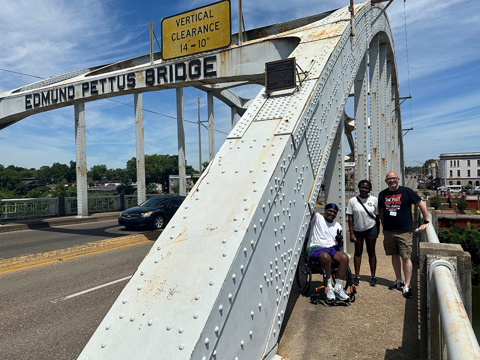 Students and teacher beside the Edmund Pettus Bridge