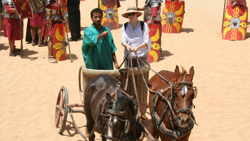 Archaeology student riding in a chariot