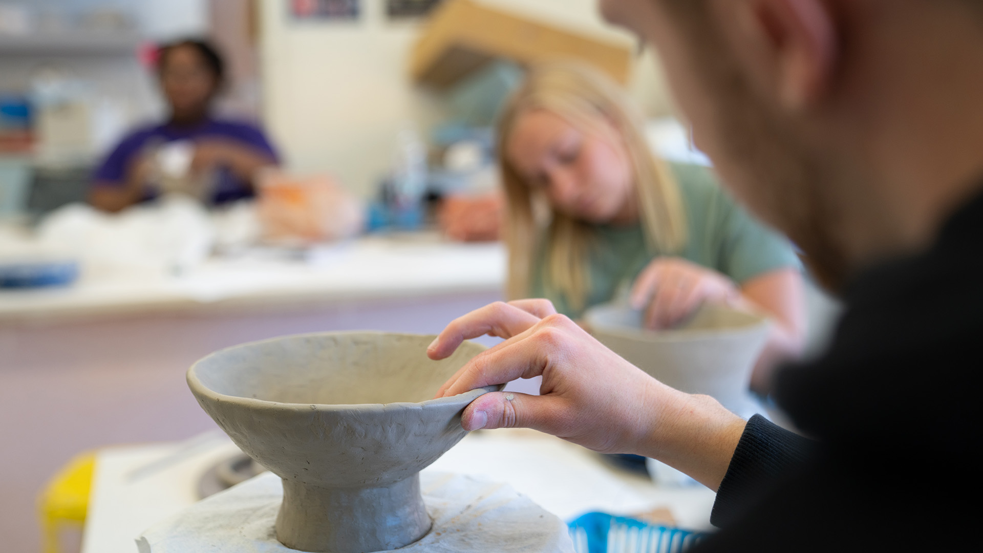 Art students making ceramic bowls