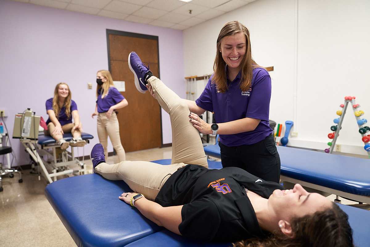 Athletic Training student bending knee