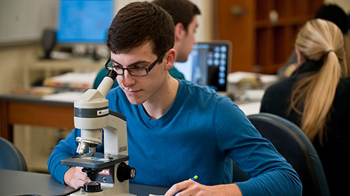 Student with microscope