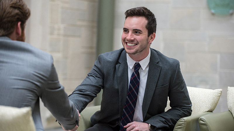 Business student giving handshake