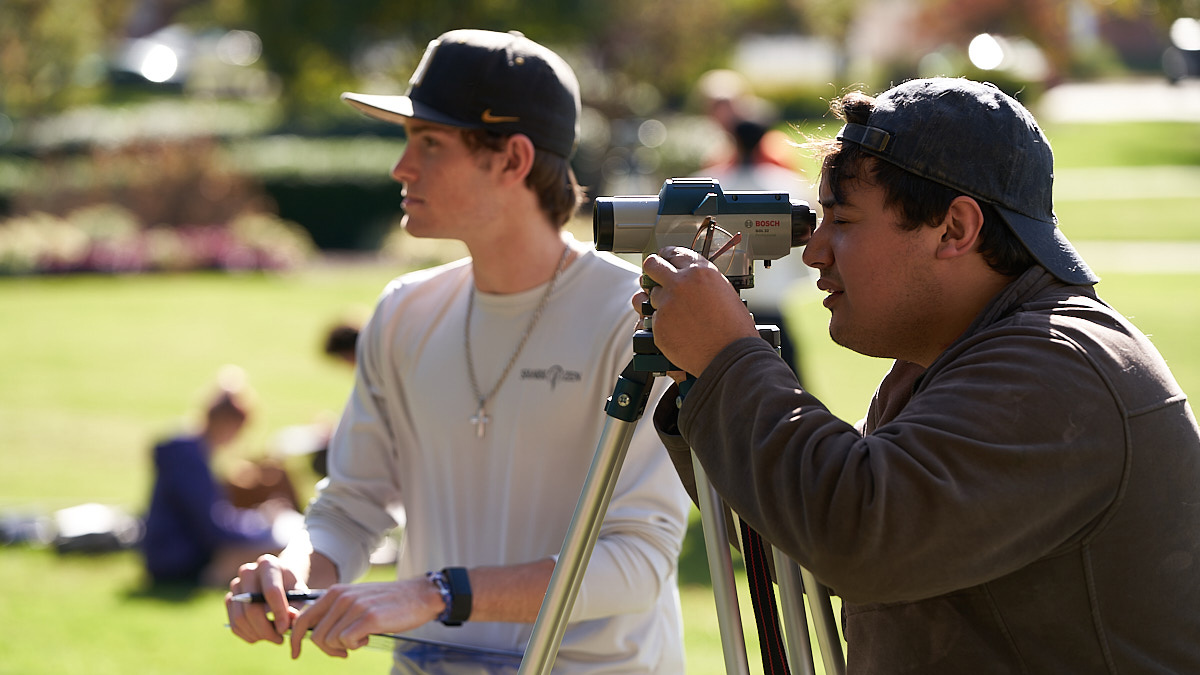 Civil Engineering students conduct a survey on campus.