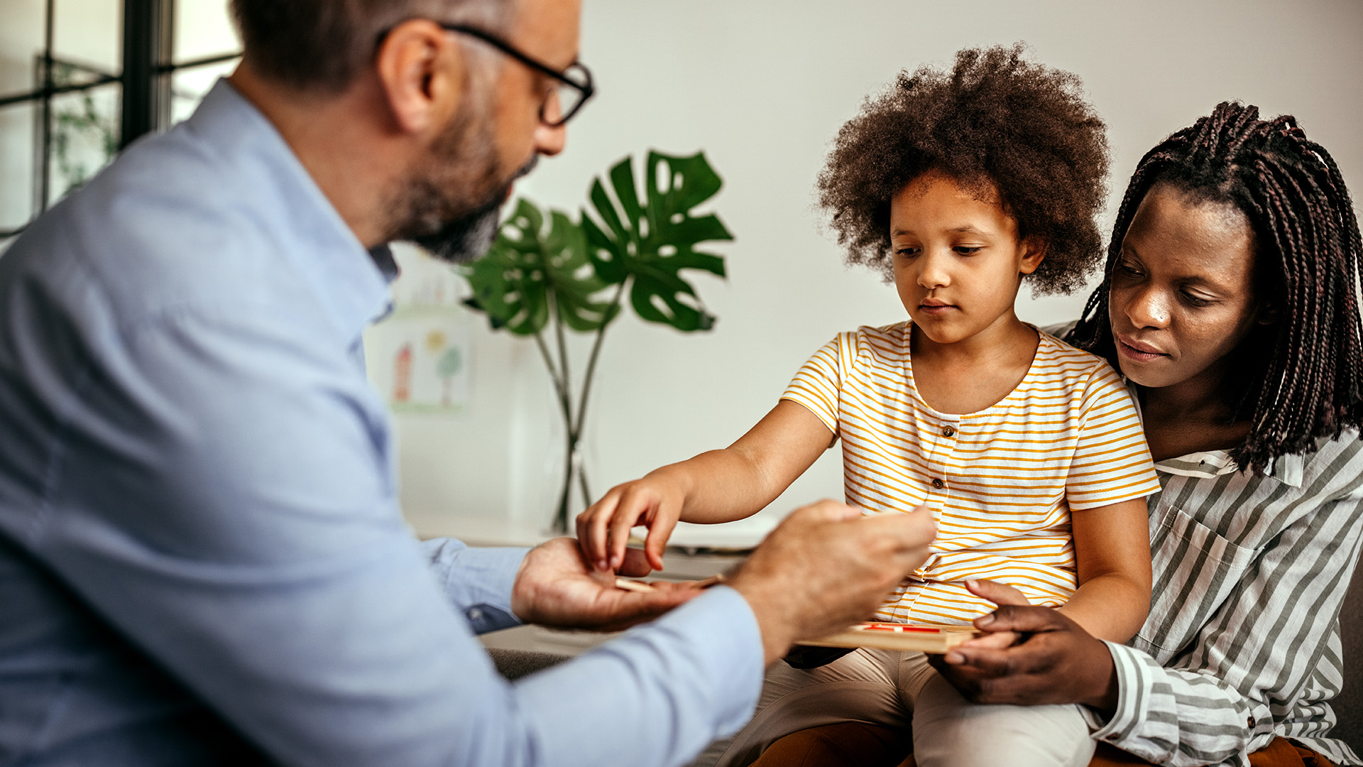 Clinical Psychology doctor with child patient and parent