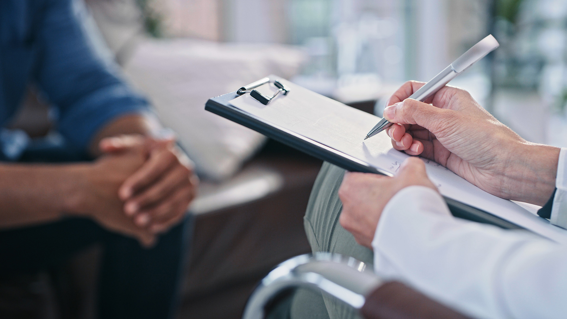 Doctor with clipboard taking notes