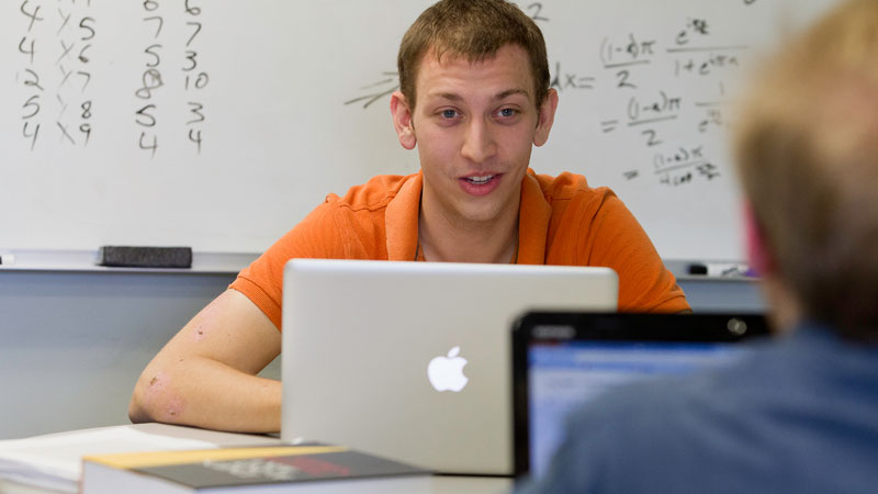 Students talking while using laptops