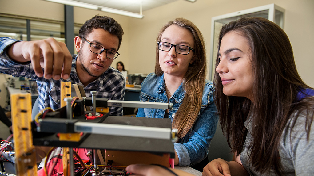 Students wiring electrical engineering project