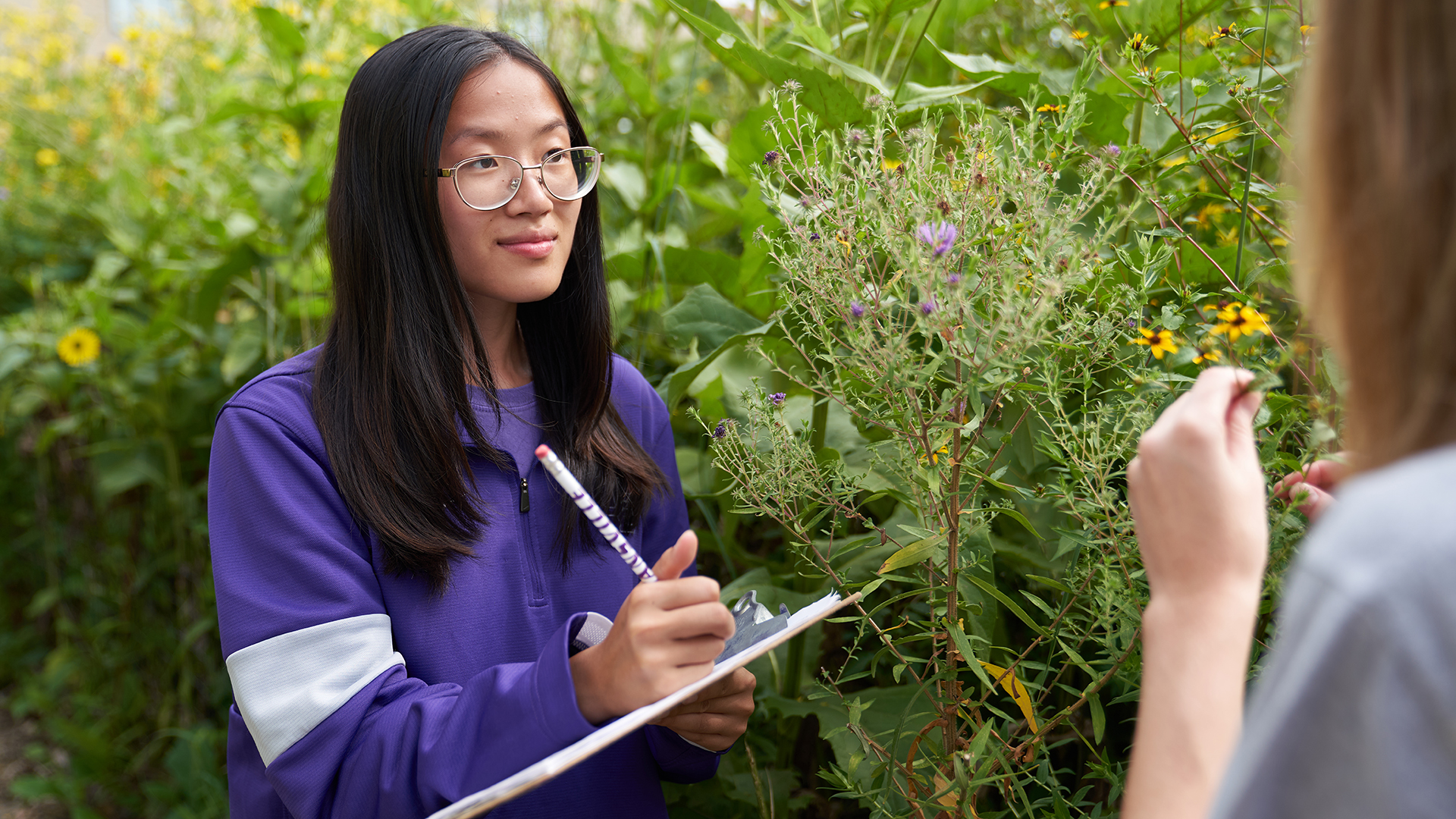 Environmental Studies student taking notes in the field