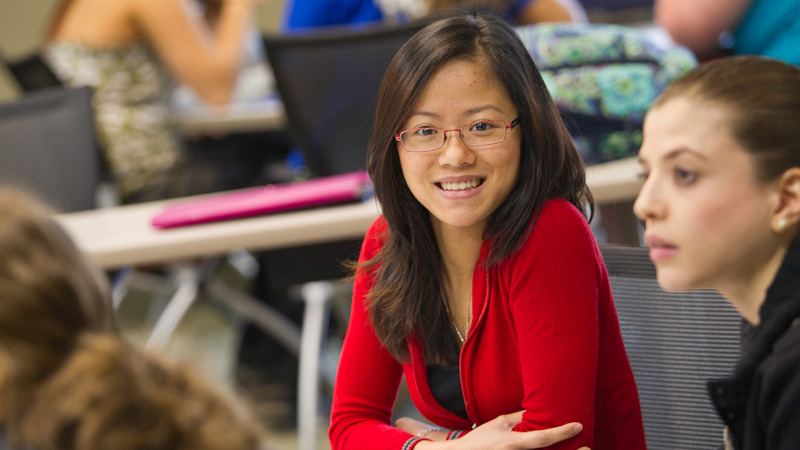 UE student in class smiling