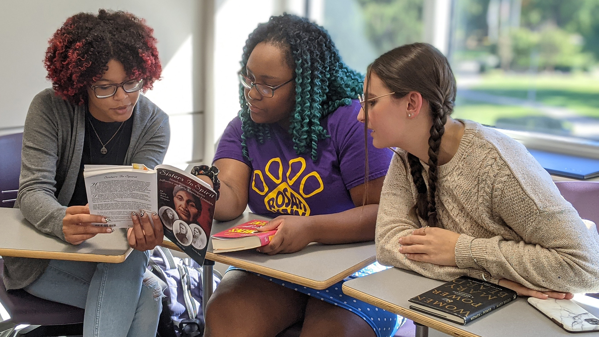 Gender and Women's Studies students group with book