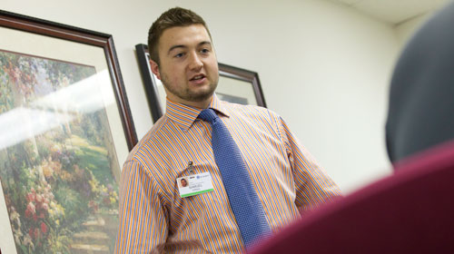 UE intern talking with patient at hospital