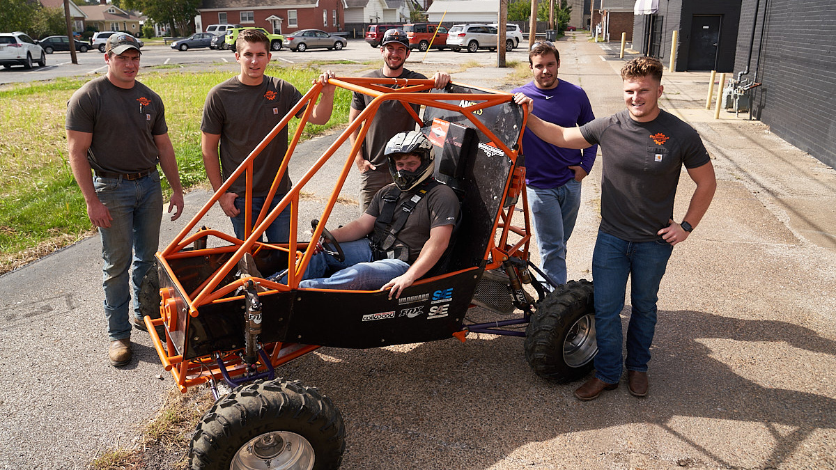 Team of students pose with the Baja Buggy they worked on