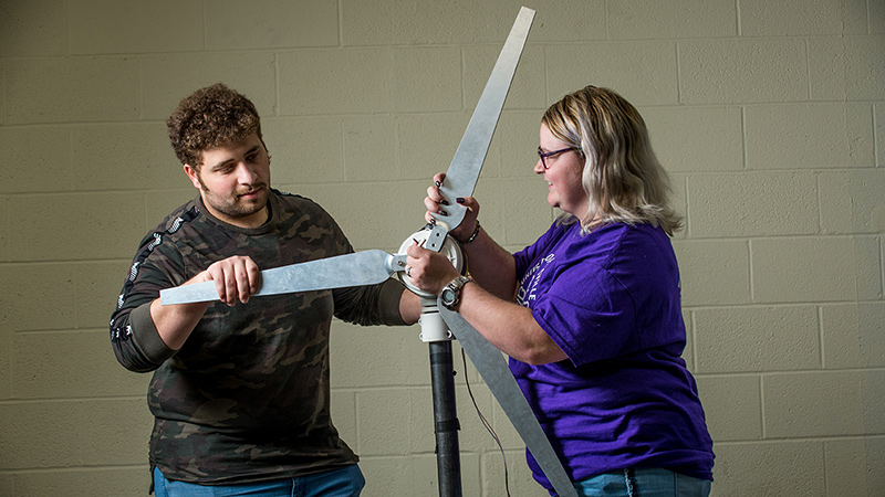 Mechanical Engineering students with wind turbine