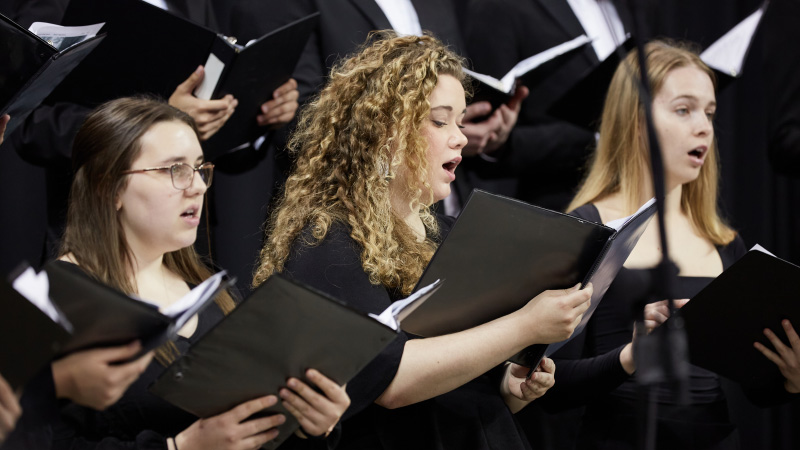 Female music students singing in choir