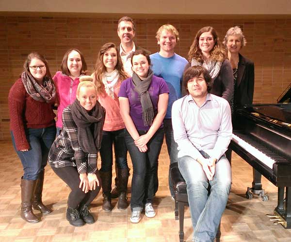 Group of UE Music students around piano