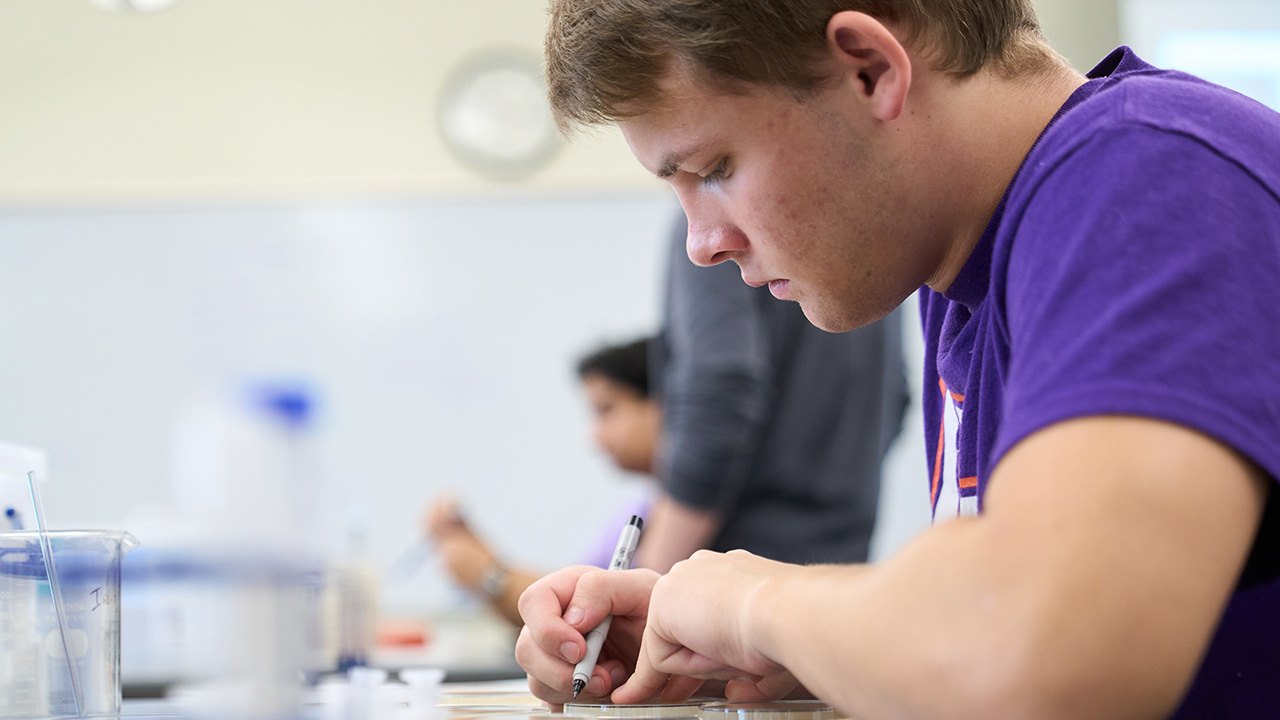 Student in neuroscience lab taking notes