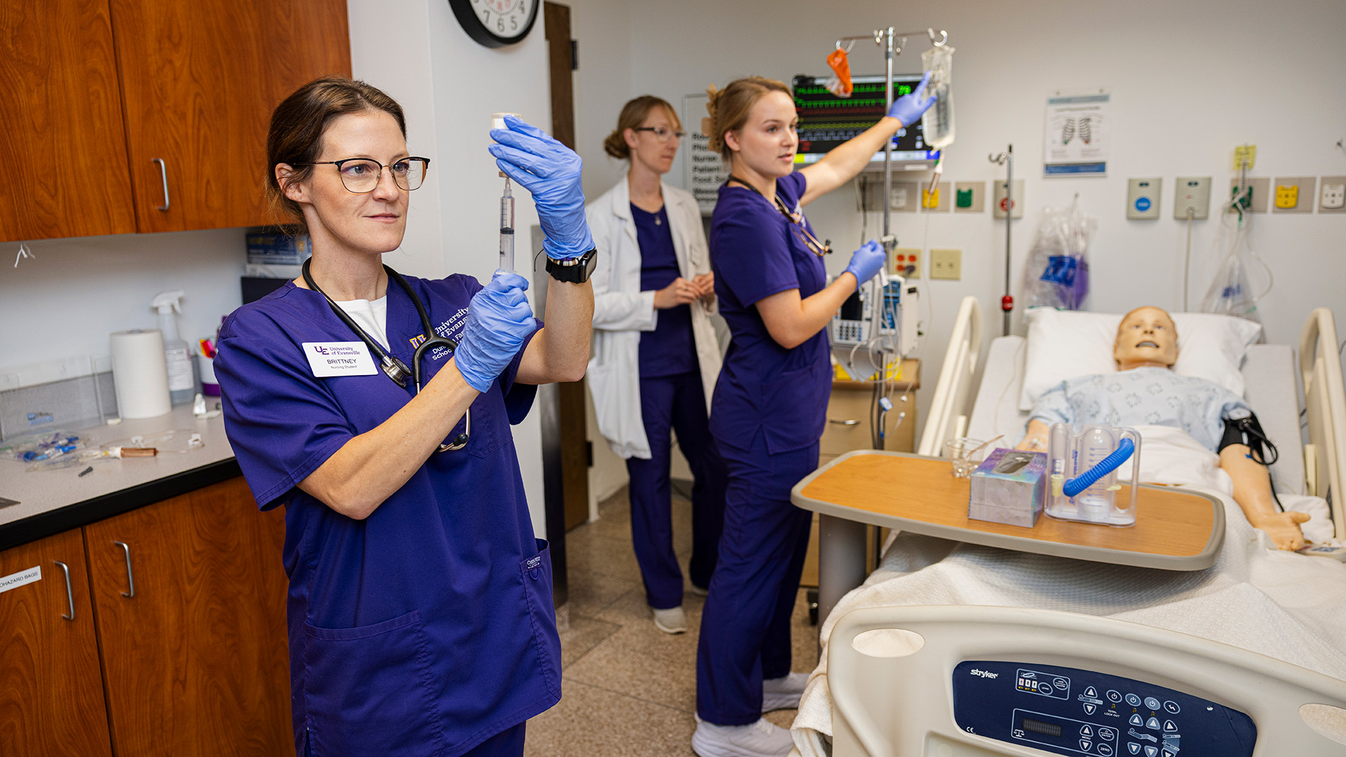 ABSN students in lab with needle