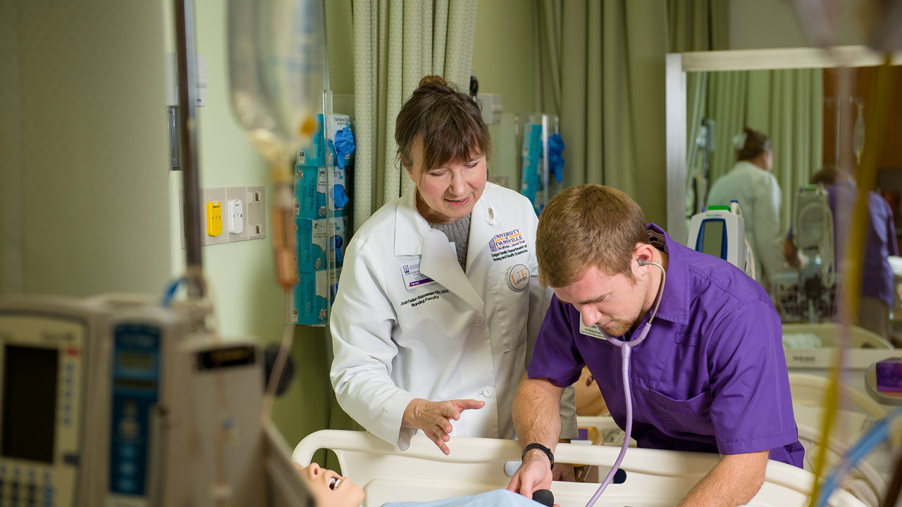 Bassemier with student in lab