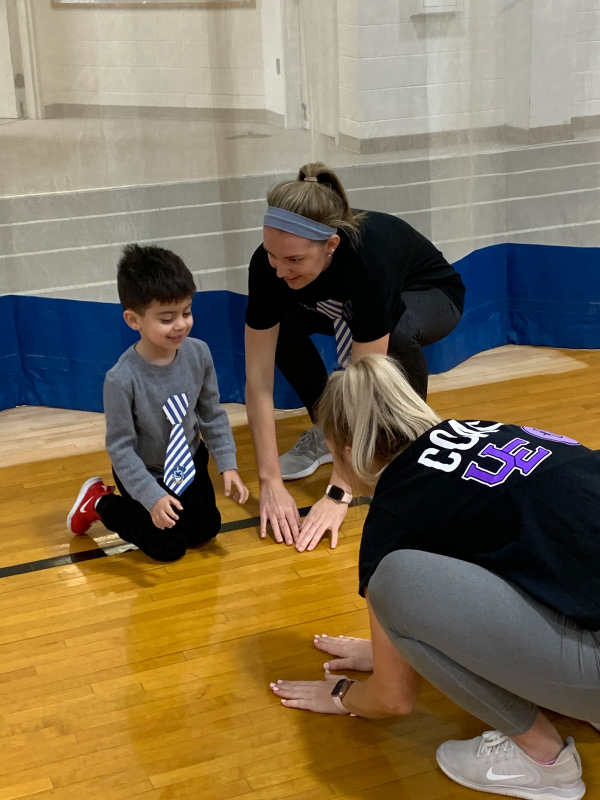 AceBuddies volunteers with child