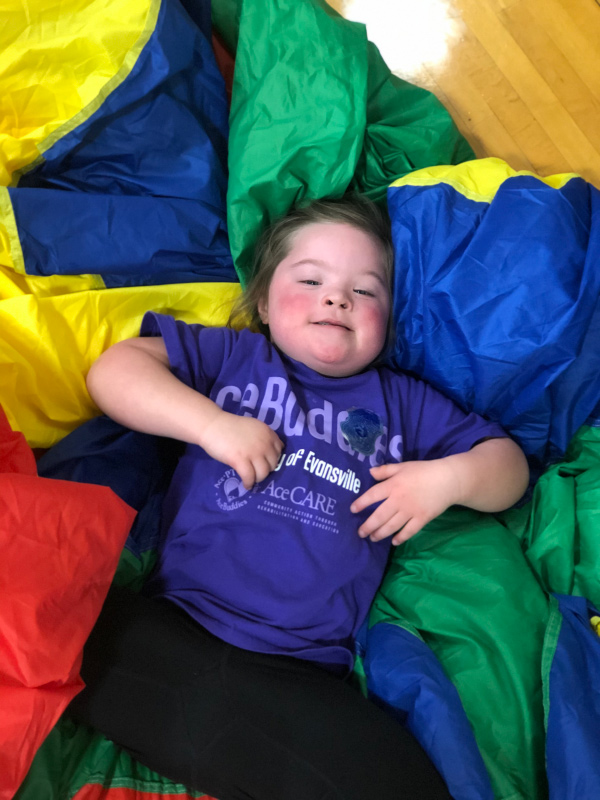 AceBuddy child lying in parachute fabric