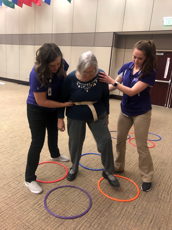 Students leading patient through hoops