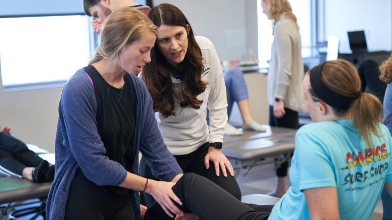 Physical Therapy students checking patient knee