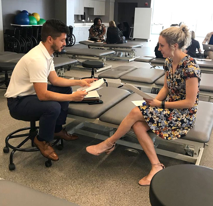 Two students in the lab with papers