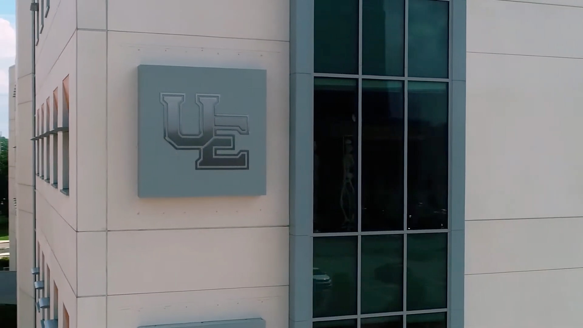 Stone Center UE sign on side of building