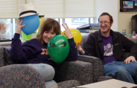 Students with baloons on a couch