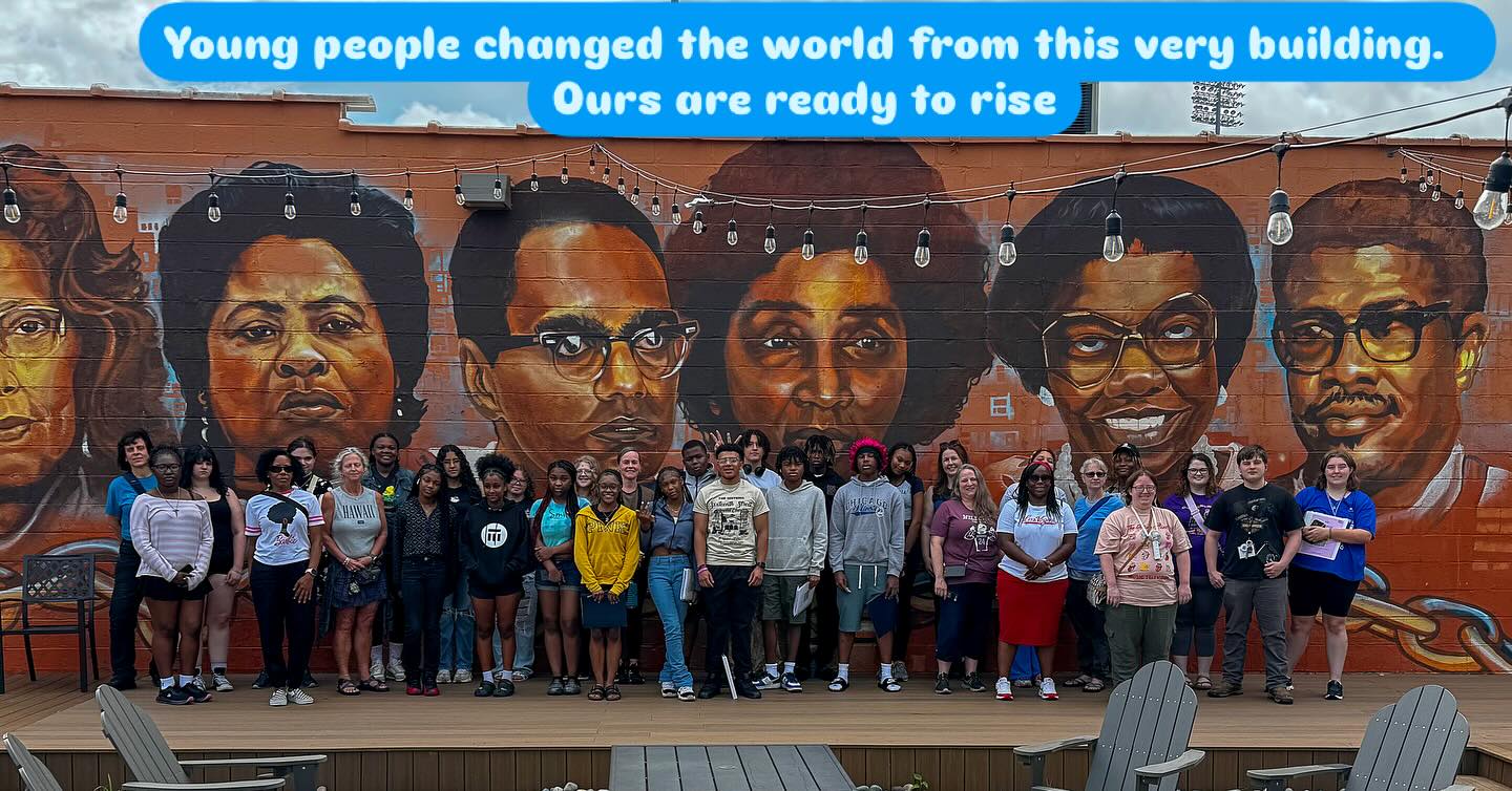 Journey to Justice students in front of memorial mural