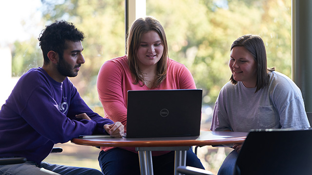 Students gathered around laptop