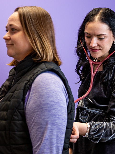 Patient being checked with stethoscope