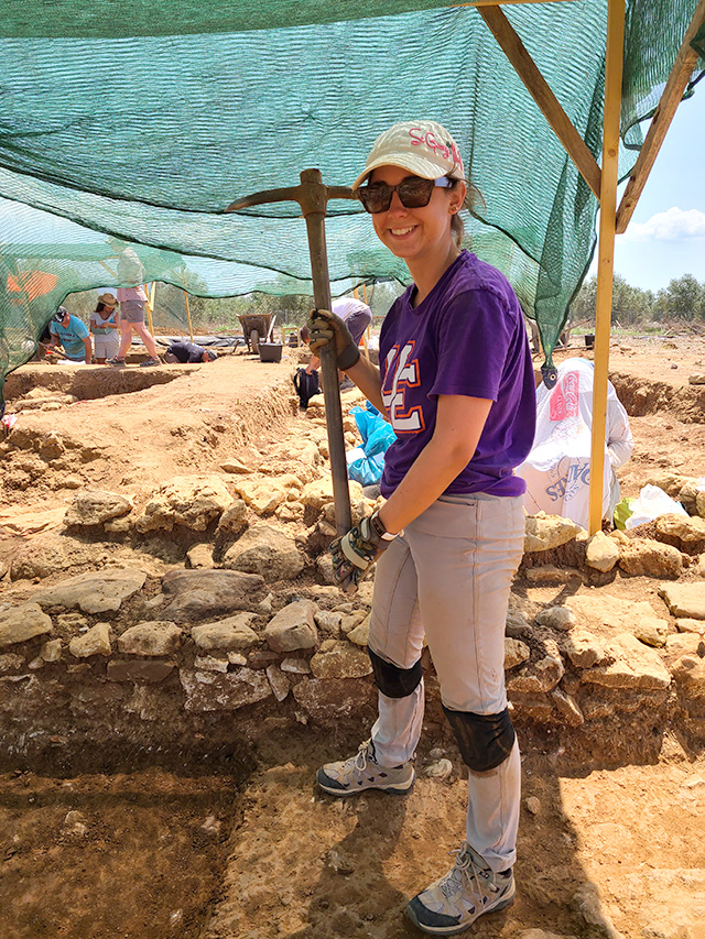 UE student Anna Robbins digging at archaeology site.