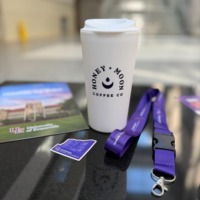 Honey Moon Coffee Co. cup with lanyard and School of Business brochure