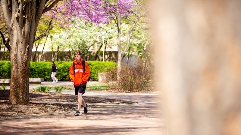Student walking across campus