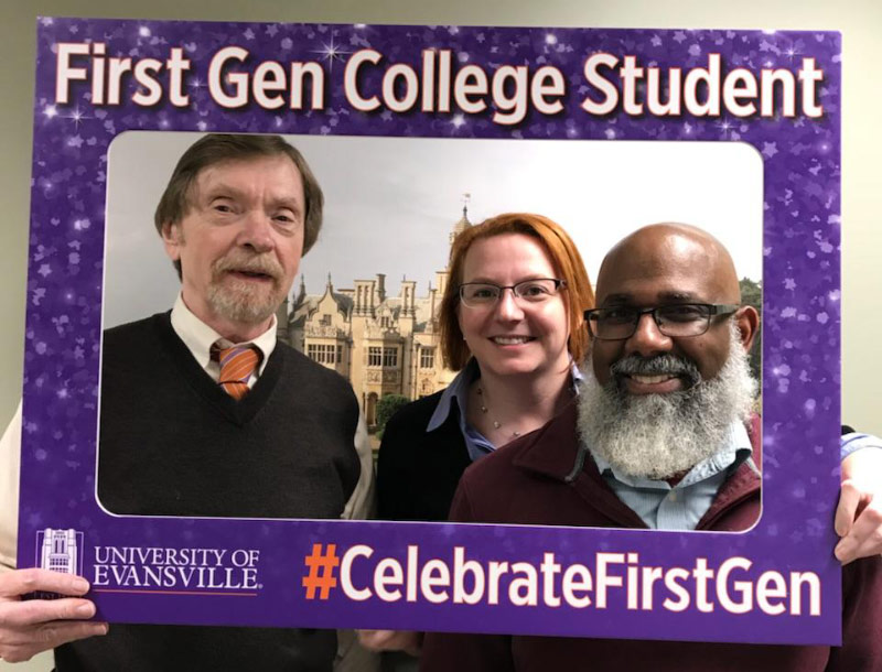 Three UE administrators hold up the First Gen sign together.