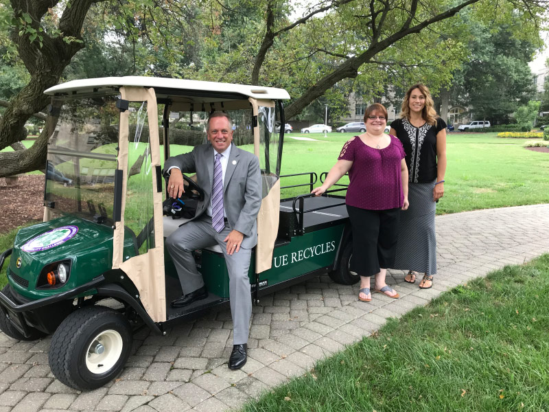 Pres P sitting in the Recycling Golf Cart